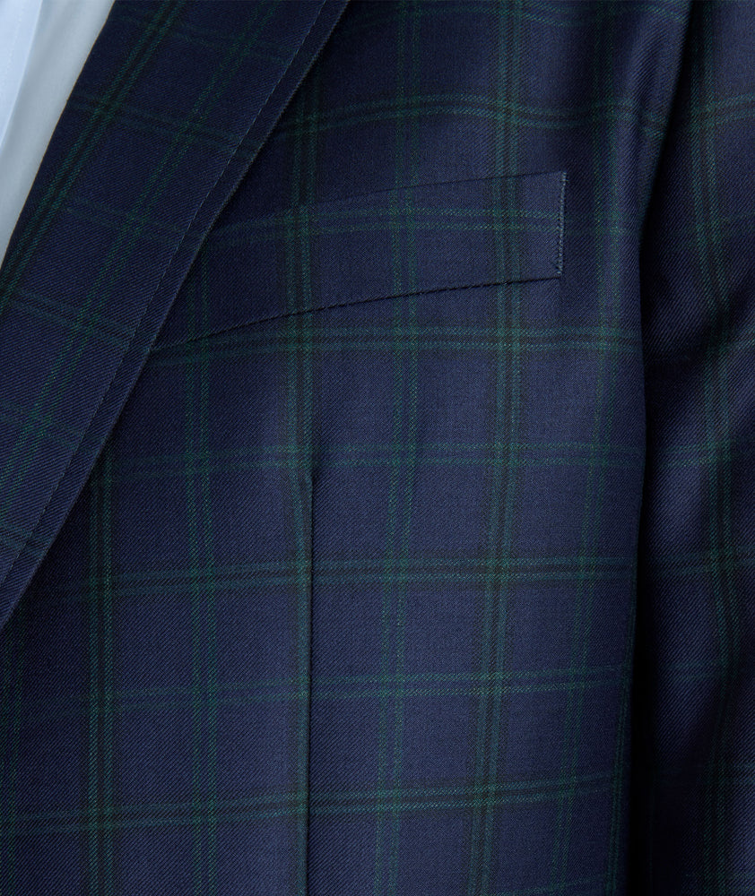 Model is wearing UNTUCKit Italian Wool Reims Sport Coat in Navy With Green Windowpane.