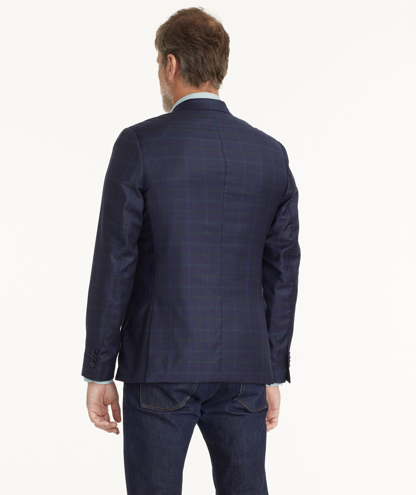 Model is wearing UNTUCKit Italian Wool Reims Sport Coat in Navy With Green Windowpane.