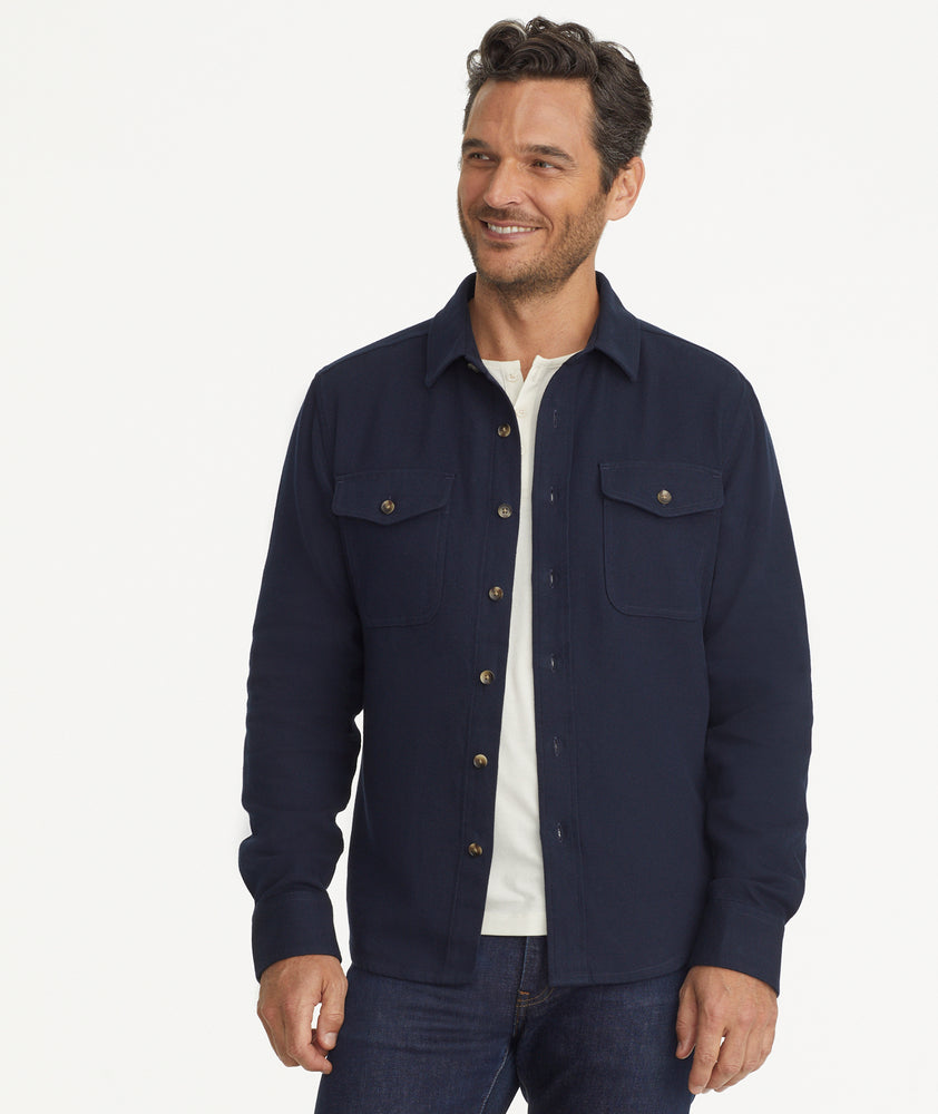 Model is wearing UNTUCKit Cotton-Linen Overshirt in Navy.