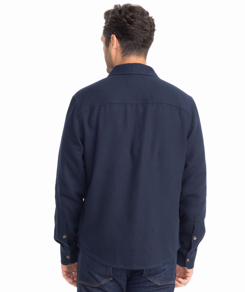 Model is wearing UNTUCKit Cotton-Linen Overshirt in Navy.