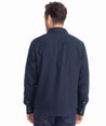 Model is wearing UNTUCKit Cotton-Linen Overshirt in Navy.