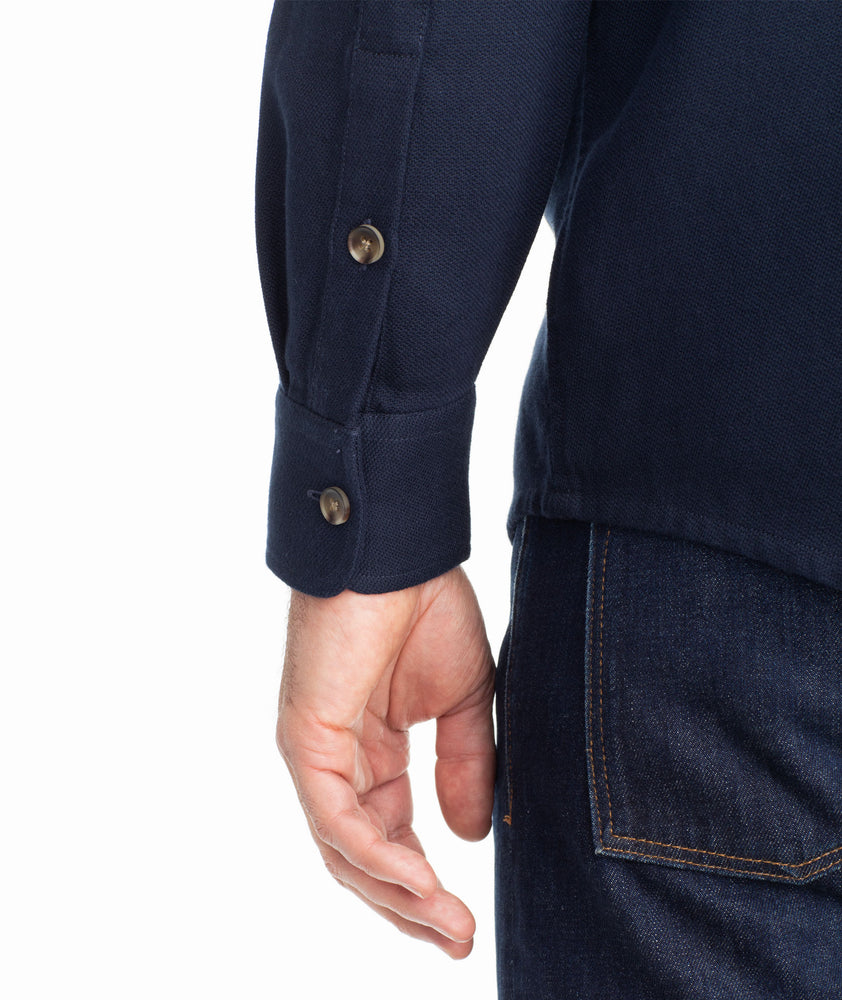 Model is wearing UNTUCKit Cotton-Linen Overshirt in Navy.