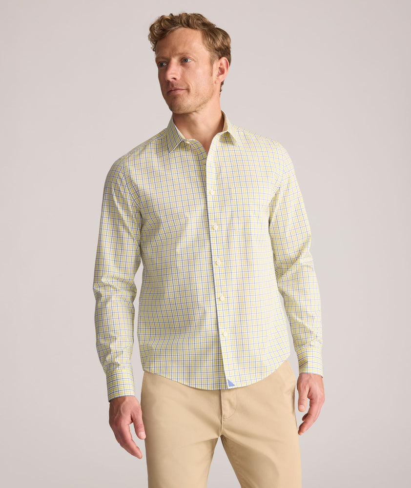 Model is wearing UNTUCKit Wrinkle-Free Ridgewell Shirt in yellow-check.