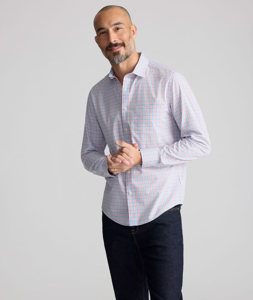 Model is wearing UNTUCKit Wrinkle-Free Ridgewell Shirt in blue-check.