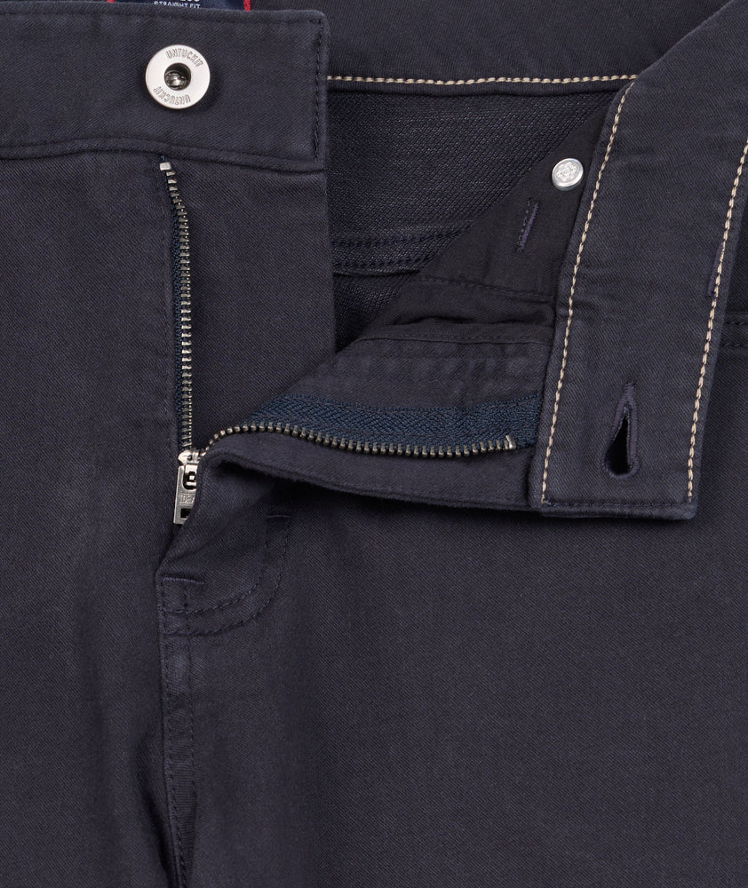 Model is wearing UNTUCKit 5-Pocket Stretch Terry Pants in Navy. 