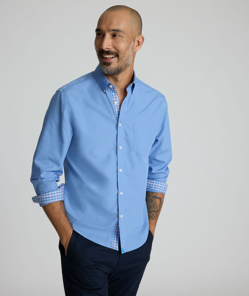 Model is wearing UNTUCKit Rosire wrinkle-free button down shirt. 