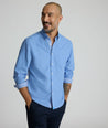 Model is wearing UNTUCKit Rosire wrinkle-free button down shirt. 