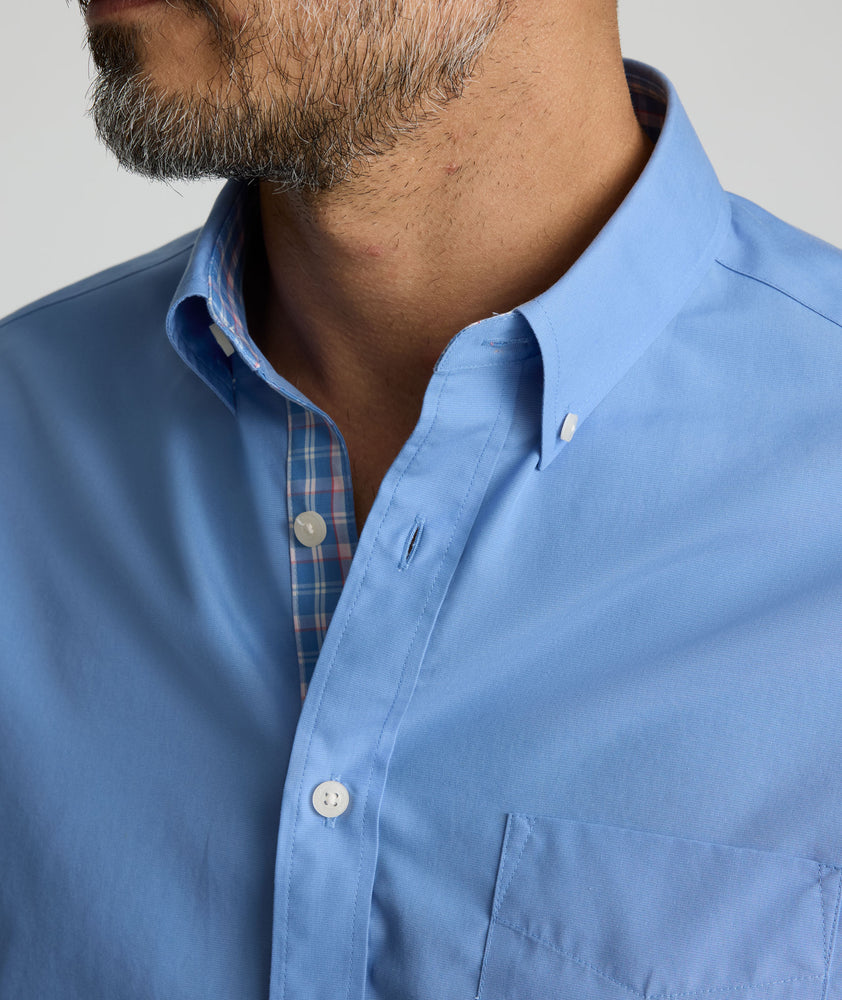Model is wearing UNTUCKit Rosire wrinkle-free button down shirt. 
