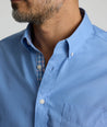 Model is wearing UNTUCKit Rosire wrinkle-free button down shirt. 