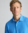 Model is wearing UNTUCKit CottonTek Polo in blue. 