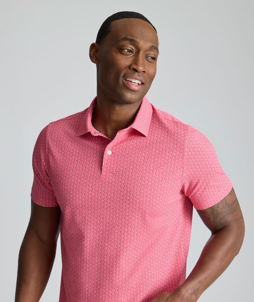 Model is wearing UNTUCKit Model is wearing UNTUCKit CottonTek Polo in Magenta Wine Bottle Print.
