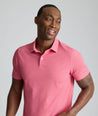 Model is wearing UNTUCKit Model is wearing UNTUCKit CottonTek Polo in Magenta Wine Bottle Print.