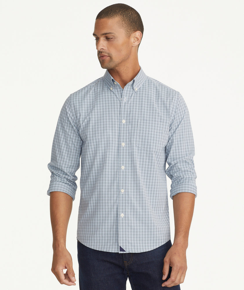 Model is wearing UNTUCKit Wrinkle-Free Performance Rowan Shirt in Blue & Navy Small Check.