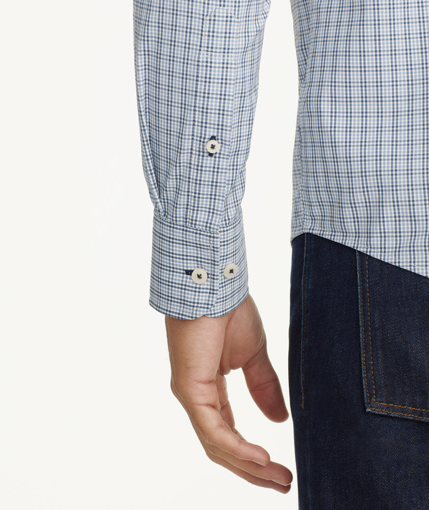 Model is wearing UNTUCKit Wrinkle-Free Performance Rowan Shirt in Blue & Navy Small Check.