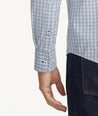 Model is wearing UNTUCKit Wrinkle-Free Performance Rowan Shirt in Blue & Navy Small Check.