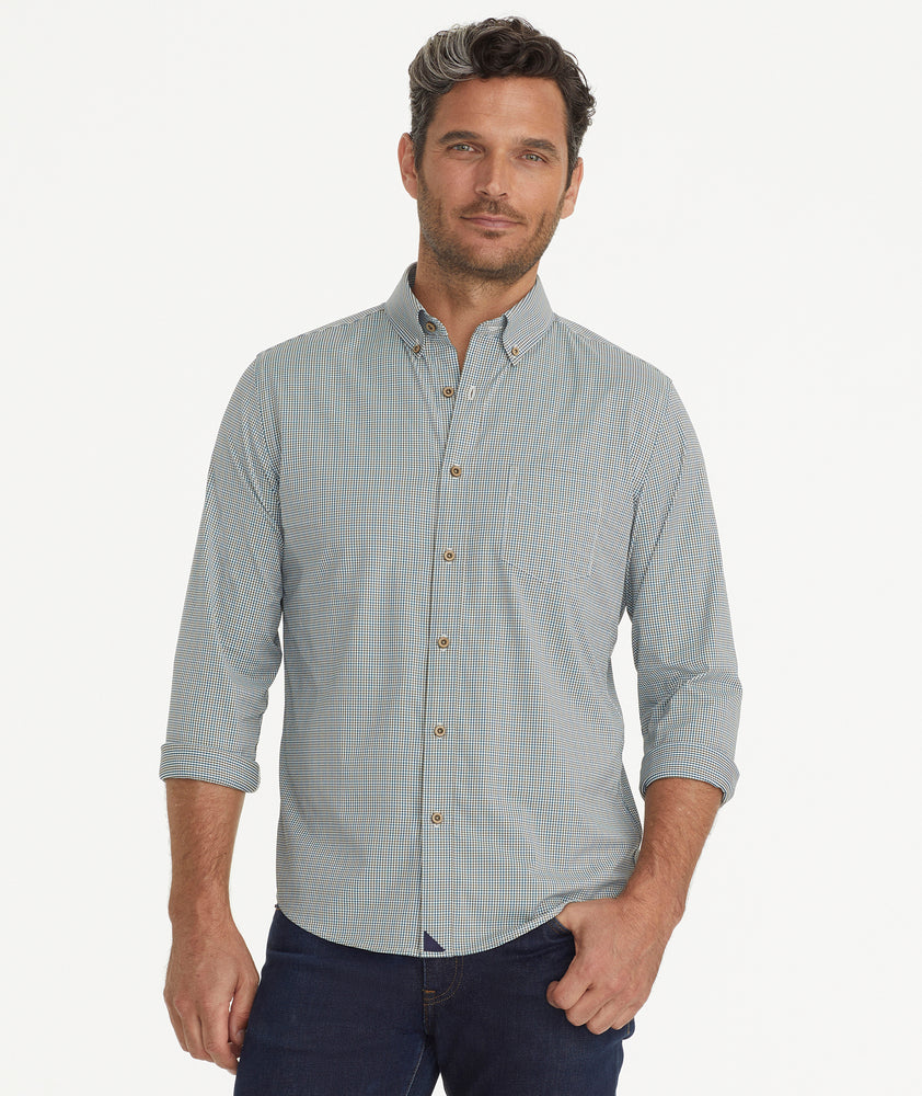Model is wearing UNTUCKit Wrinkle-Free Performance Rowan-Brown Shirt in Small Teal & Olive Check.
