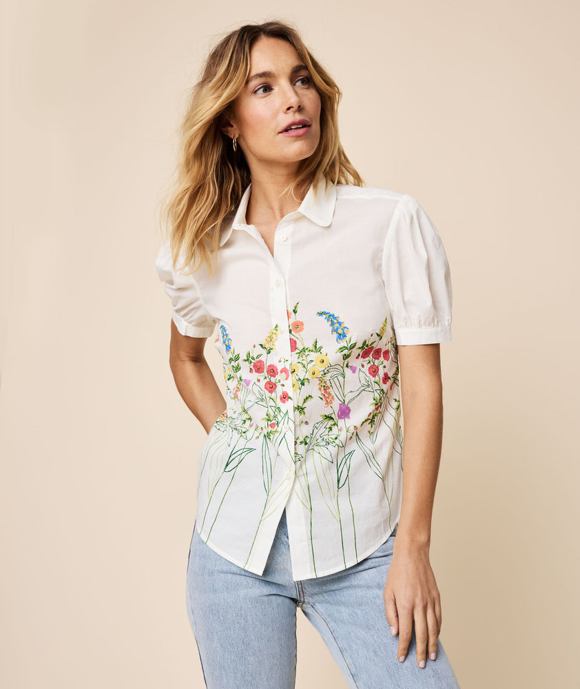 Model is wearing UNTUCKit white floral Short puff Sleeve Cotton Ruby Shirt.