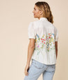 Model is wearing UNTUCKit white floral Short puff Sleeve Cotton Ruby Shirt.