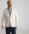 Model is wearing UNTUCKit Linen-Cotton Sagefield Sport Coat in Tan.