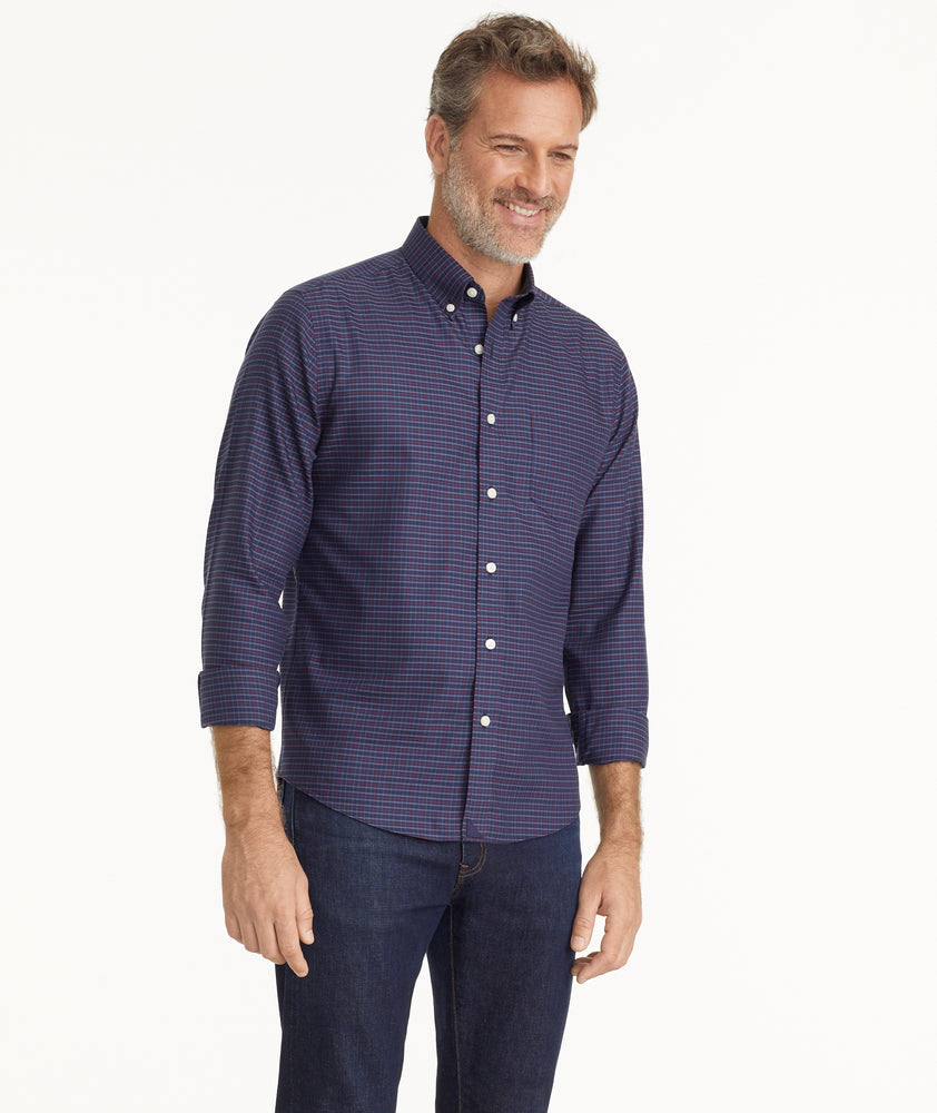 Model is wearing UNTUCKit Wrinkle-Free Salamino Shirt in Dark Blue Check.