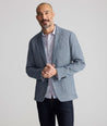 Model is wearing UNTUCKit Cotton-Blend Knit San Oro Sport Coat in Blue. 