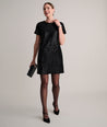 Model is wearing UNTUCKIt Sasha dress in black velvet. 