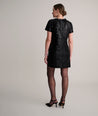 Model is wearing UNTUCKIt Sasha dress in black velvet. 