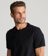 Model is wearing UNTUCKit Saxum ultra soft tee in black. 