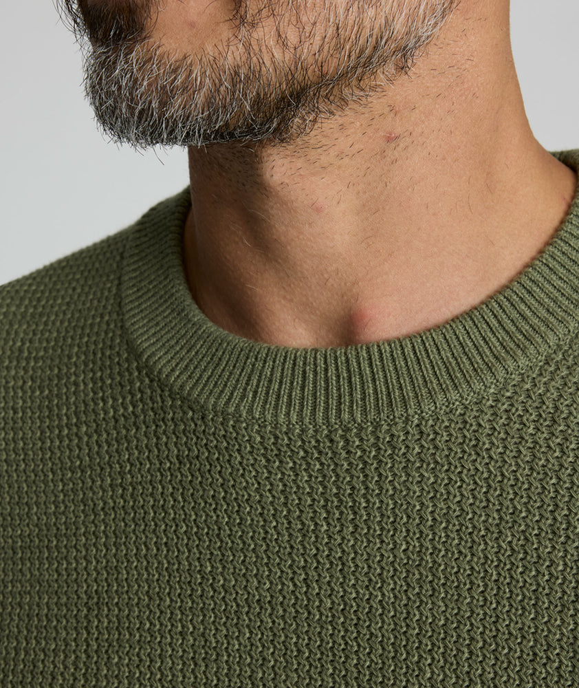 Model is wearing UNTUCKit Seaver Crewneck in Beetle Green.