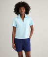 Model is wearing UNTUCKit Cotton Knit Shelby Polo in Solid Aqua Blue.