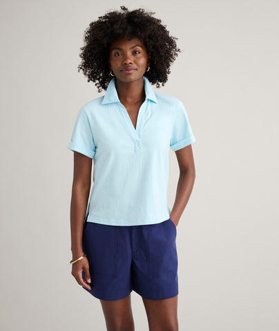 Model is wearing UNTUCKit Cotton Knit Shelby Polo in Solid Aqua Blue.