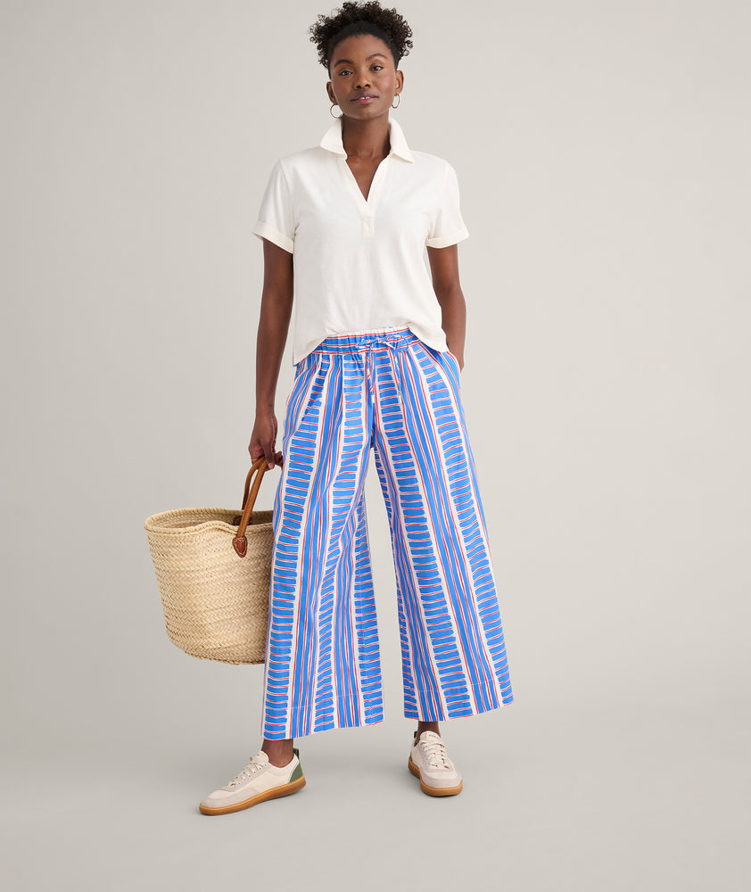 Model is wearing UNTUCKit Cotton Knit Shelby Polo in white. 