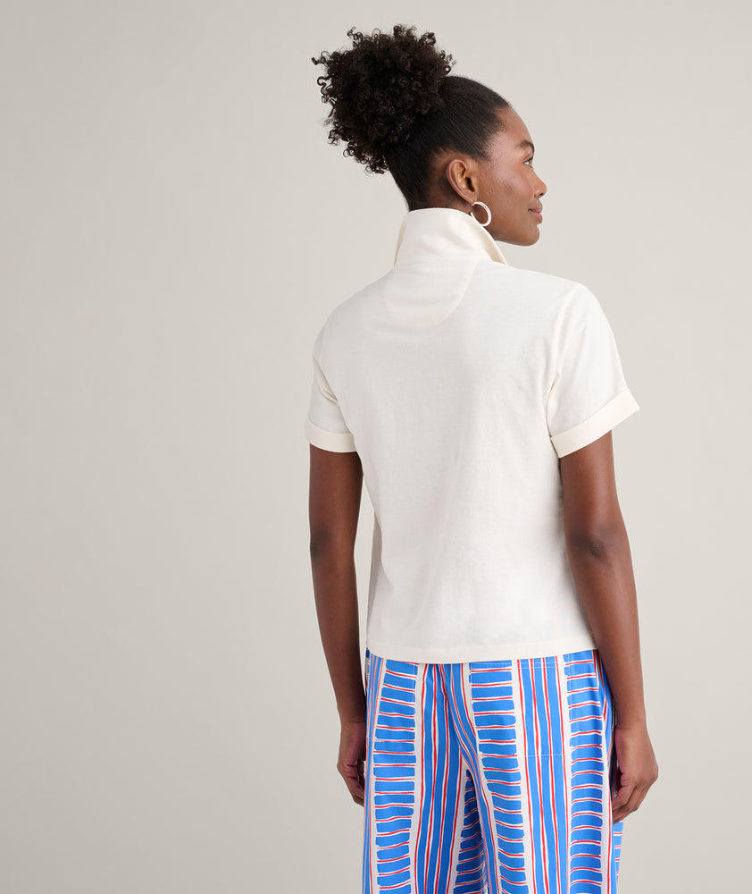 Model is wearing UNTUCKit Cotton Knit Shelby Polo in white. 