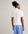 Model is wearing UNTUCKit Cotton Knit Shelby Polo in white. 