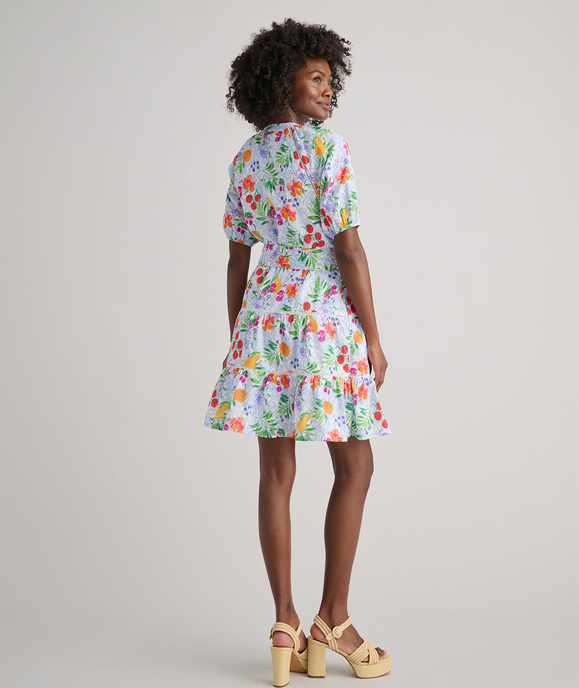 Model is wearing UNTUCKit Sierra dress in fruit print.