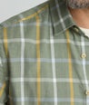 Model is wearing UNTUCKit Silva flannel in green.