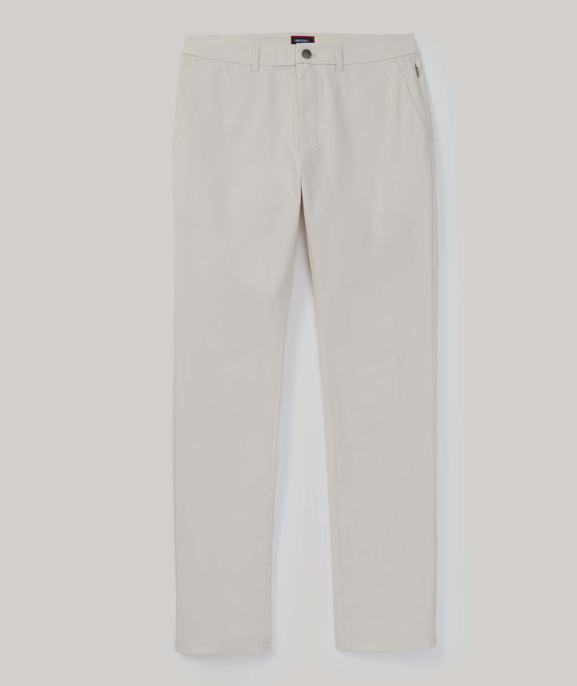 Model is wearing UNTUCKit Traveler Tech Pants in silver birch .