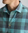 Model is wearing UNTUCKit Vintage Wash Short-Sleeve Silverstone Shirt in blue. 