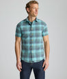 Model is wearing UNTUCKit Vintage Wash Short-Sleeve Silverstone Shirt in blue. 