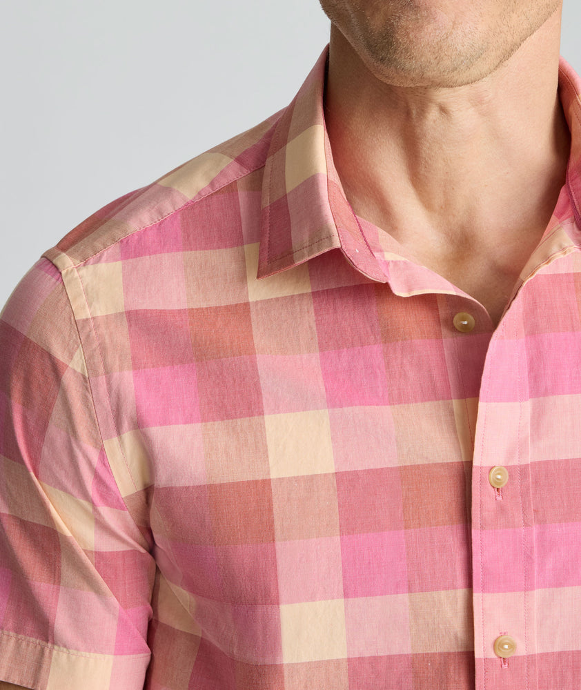Model is wearing UNTUCKit Vintage Wash Short-Sleeve Silverstone Shirt in pink. 