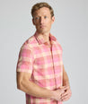 Model is wearing UNTUCKit Vintage Wash Short-Sleeve Silverstone Shirt in pink. 