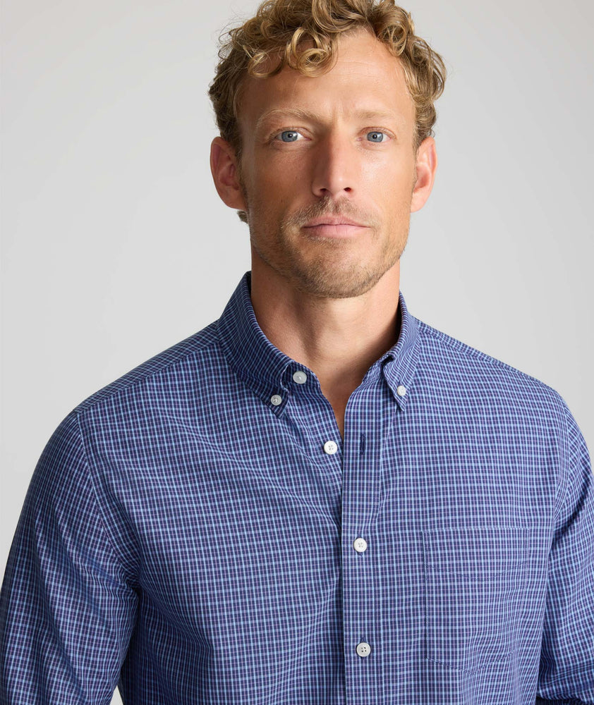 Model is wearing UNTUCKit Wrinkle-Free Solay Shirt in Navy Check.