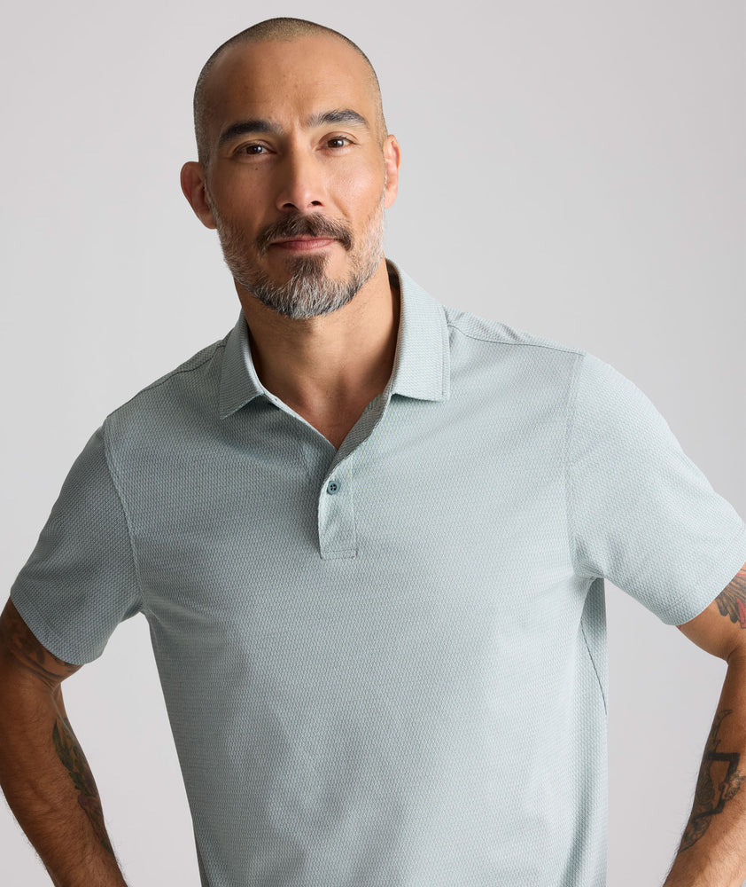 Model is wearing UNTUCKit Textured Performance Polo in green. 