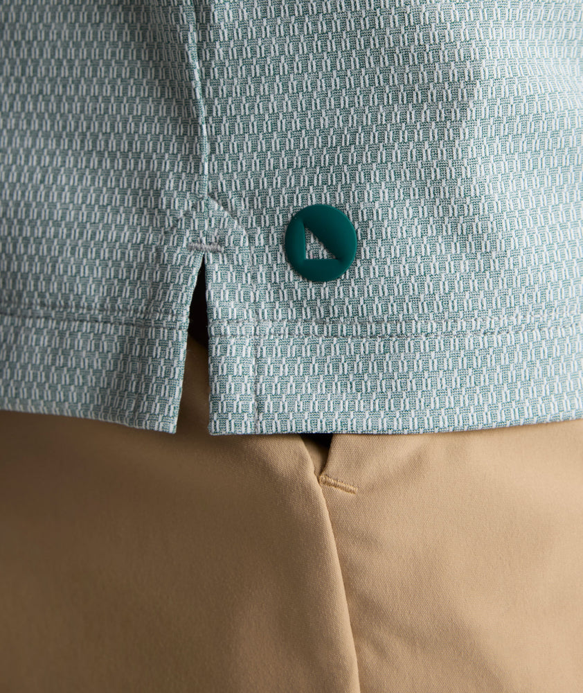 Model is wearing UNTUCKit Textured Performance Polo in green. 