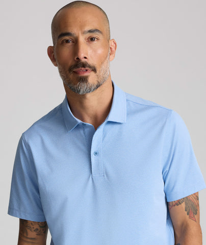 Model is wearing UNTUCKit Textured Performance Polo in blue. 
