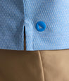 Model is wearing UNTUCKit Textured Performance Polo in blue. 