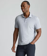 Model is wearing UNTUCKit Textured Performance Polo in navy. 
