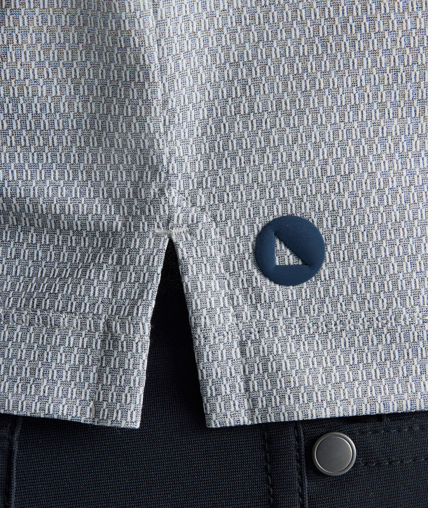 Model is wearing UNTUCKit Textured Performance Polo in navy. 
