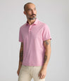 Model is wearing UNTUCKit Textured Performance Polo	in Red.