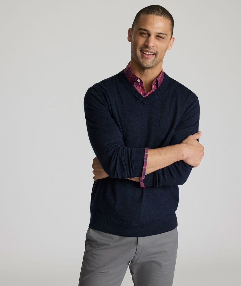 Model is wearing UNTUCKit sweater in navy.